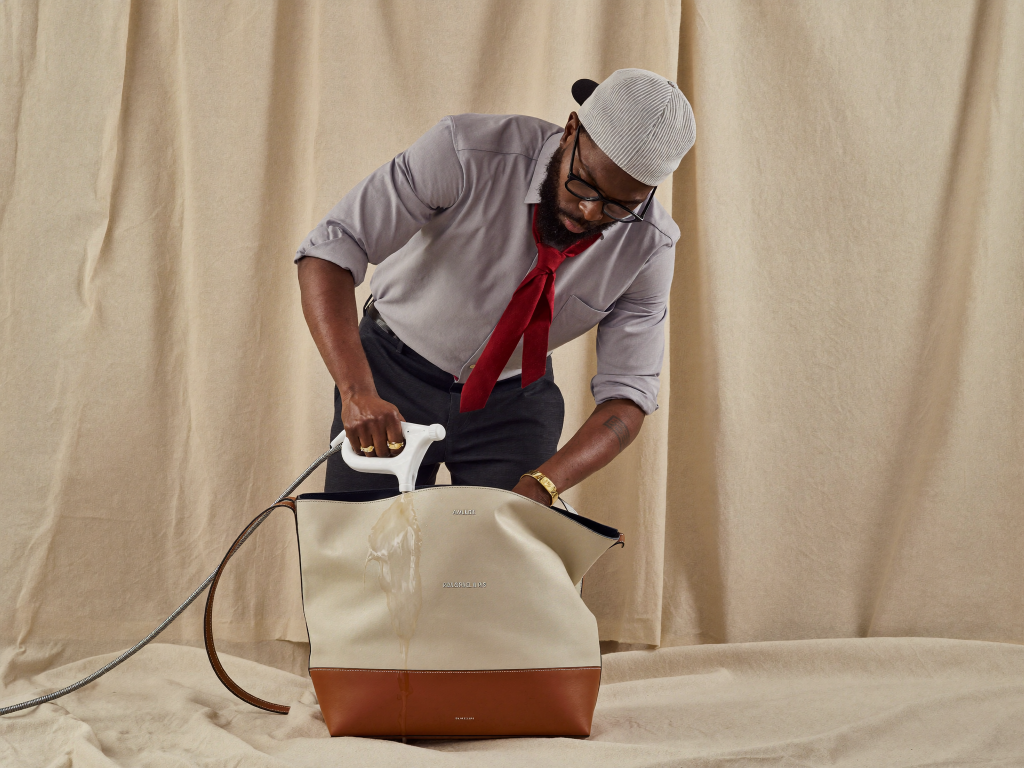 Man cleaning a canvas tote bag
