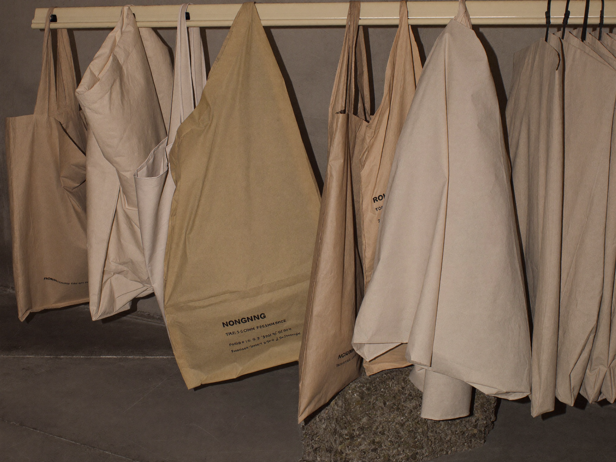A row of canvas totes hanging in a closet, ready for storage
