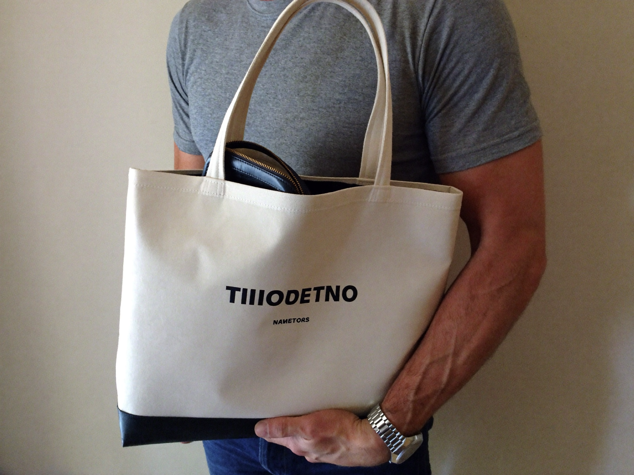 Structured men's tote bag with reinforced base and exterior pockets