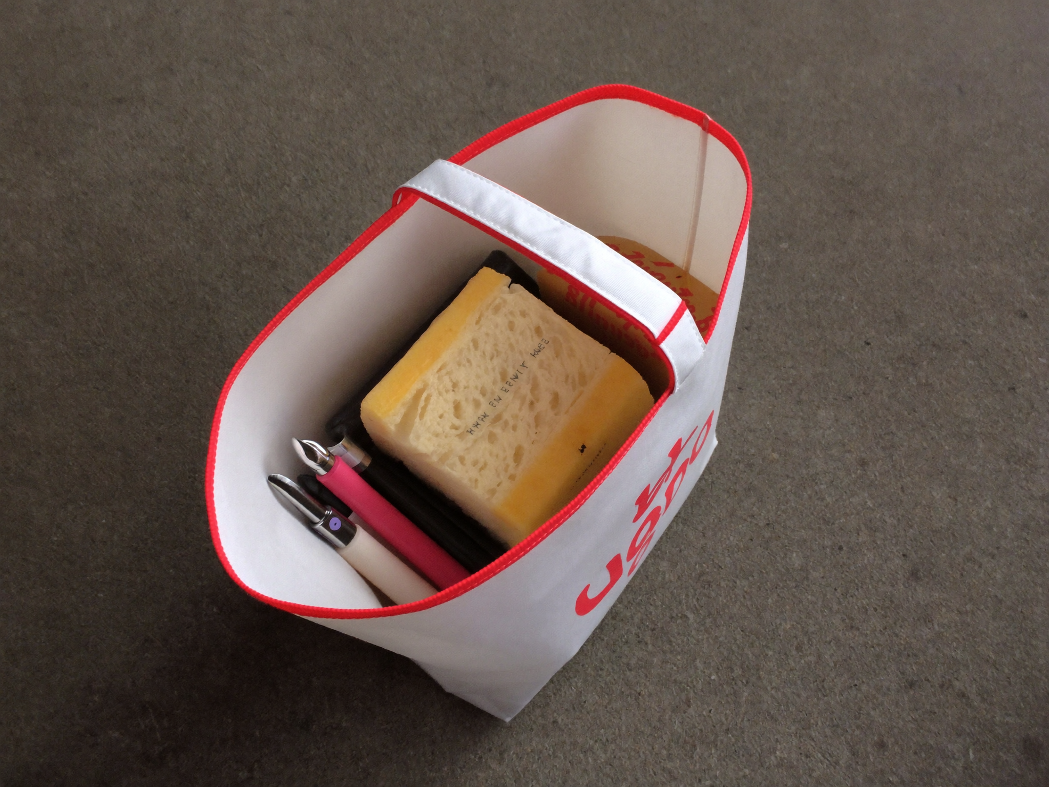 Insulated lunch tote packed with food containers and a drink